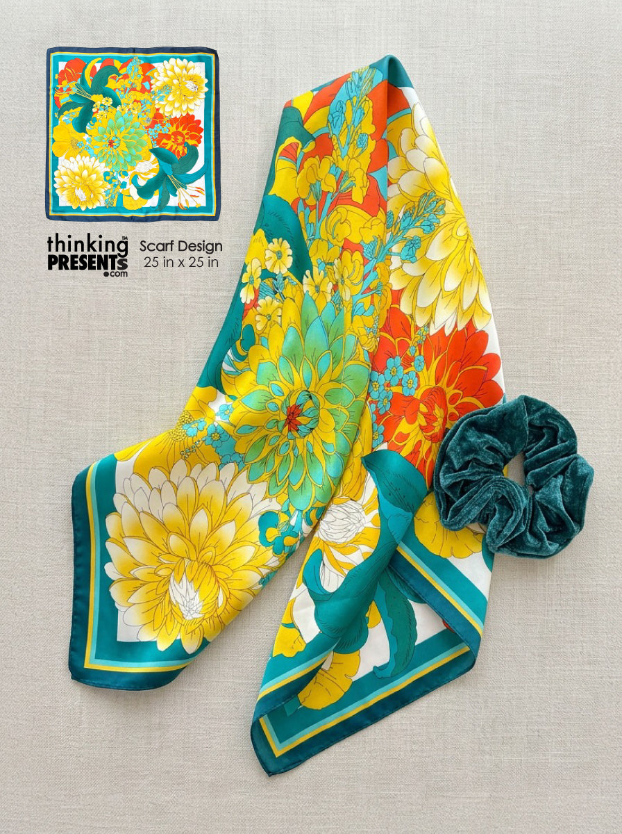 Colorful floral scarf with a matching scrunchie on a textured surface