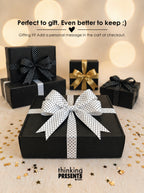 Black gift boxes with decorative bows on a decorative surface with text overlay.