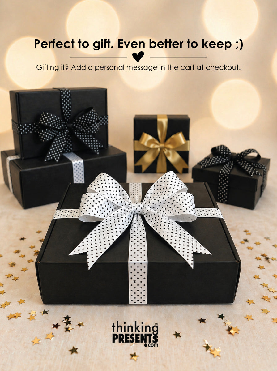 Black gift boxes with decorative bows on a decorative surface with text overlay.
