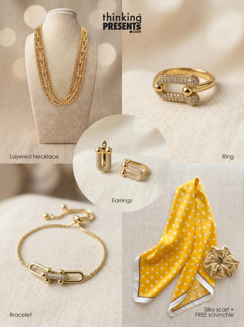Bright Affair gift set featuring a layered gold necklace, pavé gold ring, matching earrings, adjustable bracelet, and a yellow polka dot silky scarf with scrunchie