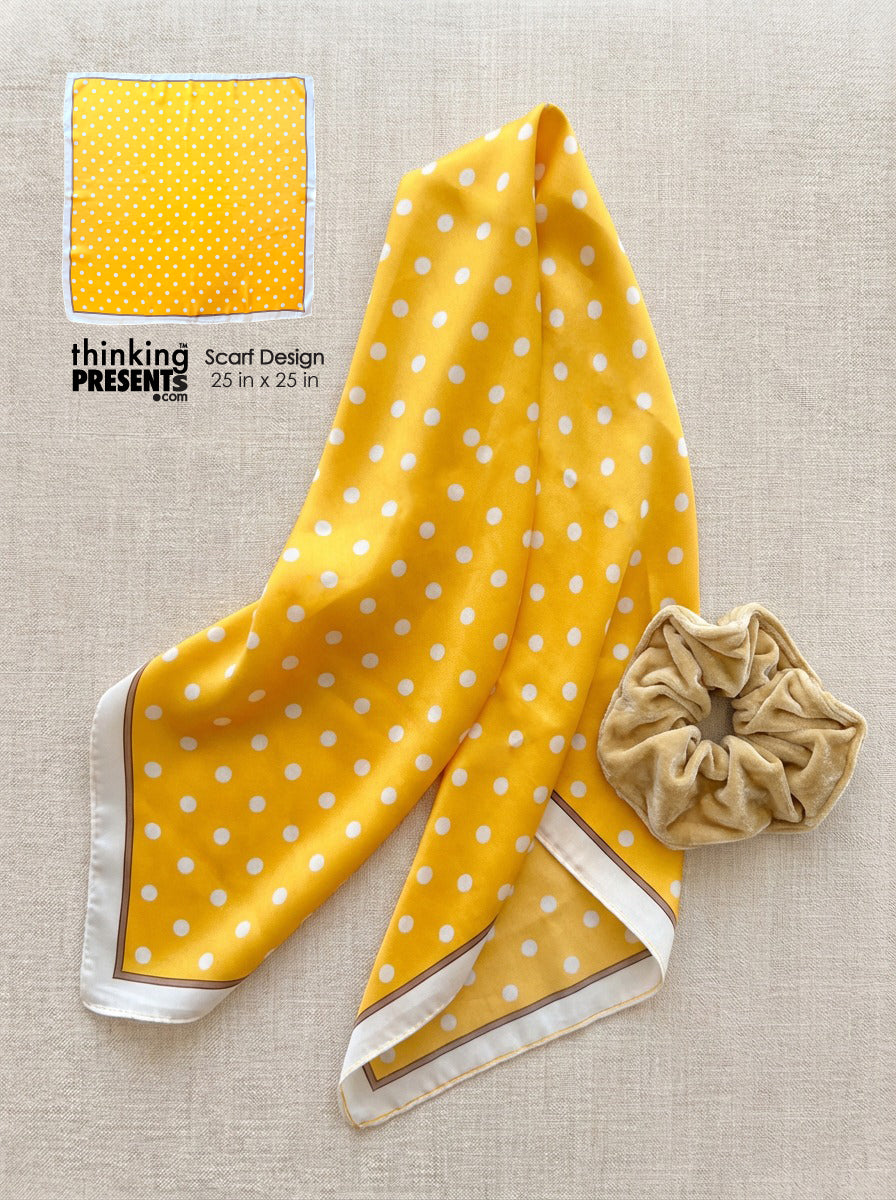 Yellow polka dot scarf with a beige scrunchie on a beige background