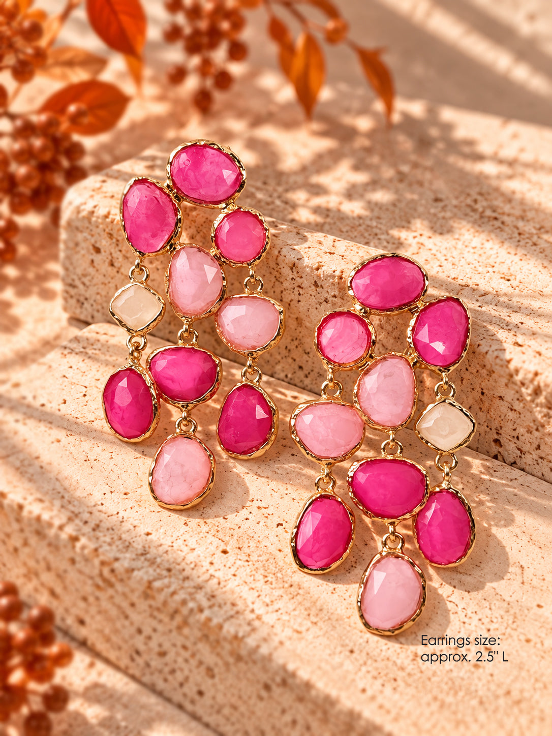 Gold-tone statement chandelier earrings with fuchsia, blush pink, and ivory stones