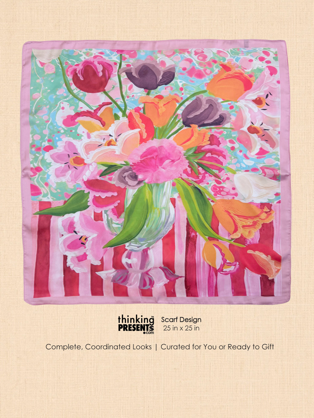 A square scarf with a colorful floral and botanical print, featuring pink, orange, purple, and green flowers with a striped pink and white base, displayed on a beige textured background with product details below.