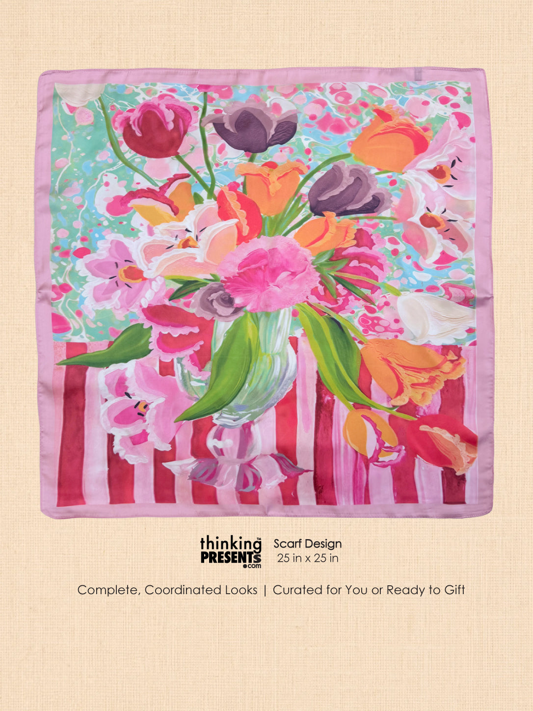 A square scarf with a colorful floral and botanical print, featuring pink, orange, purple, and green flowers with a striped pink and white base, displayed on a beige textured background with product details below.