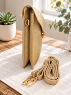 Metallic gold vegan crossbody bag by Thinking Presents with gold-tone push lock and removable adjustable strap