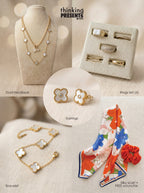 Layered gold-tone necklace with black and white floral accents displayed on a neutral bust, part of the Midnight Bloom Gift Set by Thinking Presents™