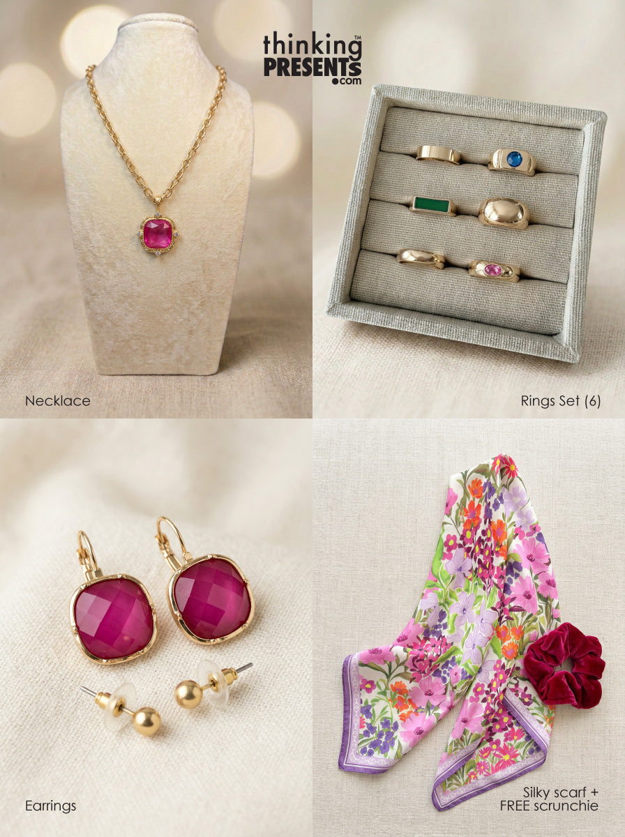 Curated gift set featuring gold-tone necklace with magenta stone pendant, six-piece ring set with mixed colorful accents, matching statement earrings, delicate stud earrings, and a vibrant floral silky scarf with velvet-touch scrunchie, styled as a bold and feminine ready-to-gift set