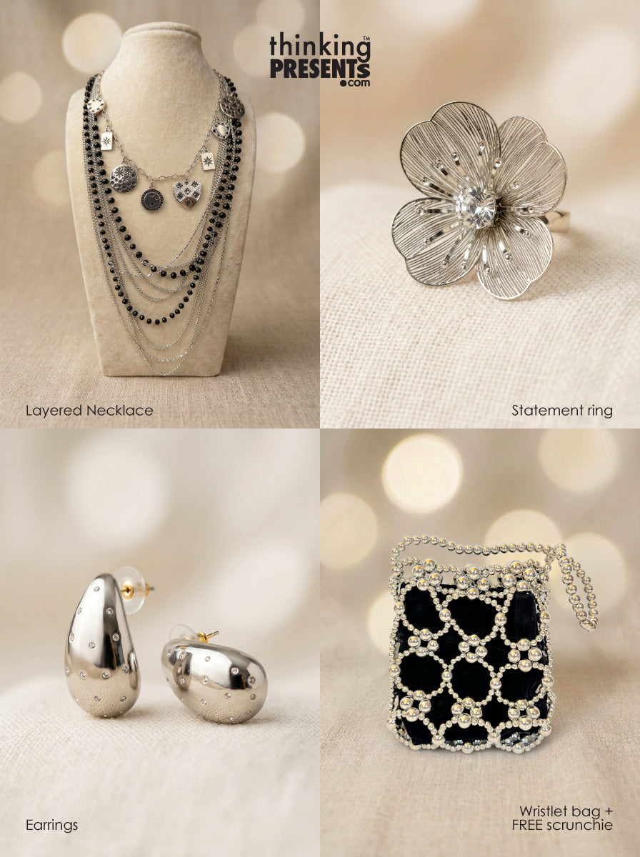 Collection of jewelry including a layered necklace, statement ring, earrings, and a wristlet bag with a free scrunchie on a neutral background.