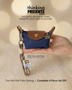Wrist strap coin purse held by a hand with 'thinking PRESENTS' branding.