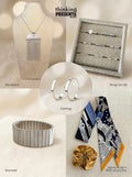 Curated gift set featuring silver-tone statement necklace with fringe detail, eight-piece ring set, minimalist hoop earrings, structured stretch bracelet, and a patterned skinny scarf with velvet-touch scrunchie, styled as a modern and elegant ready-to-gift set
