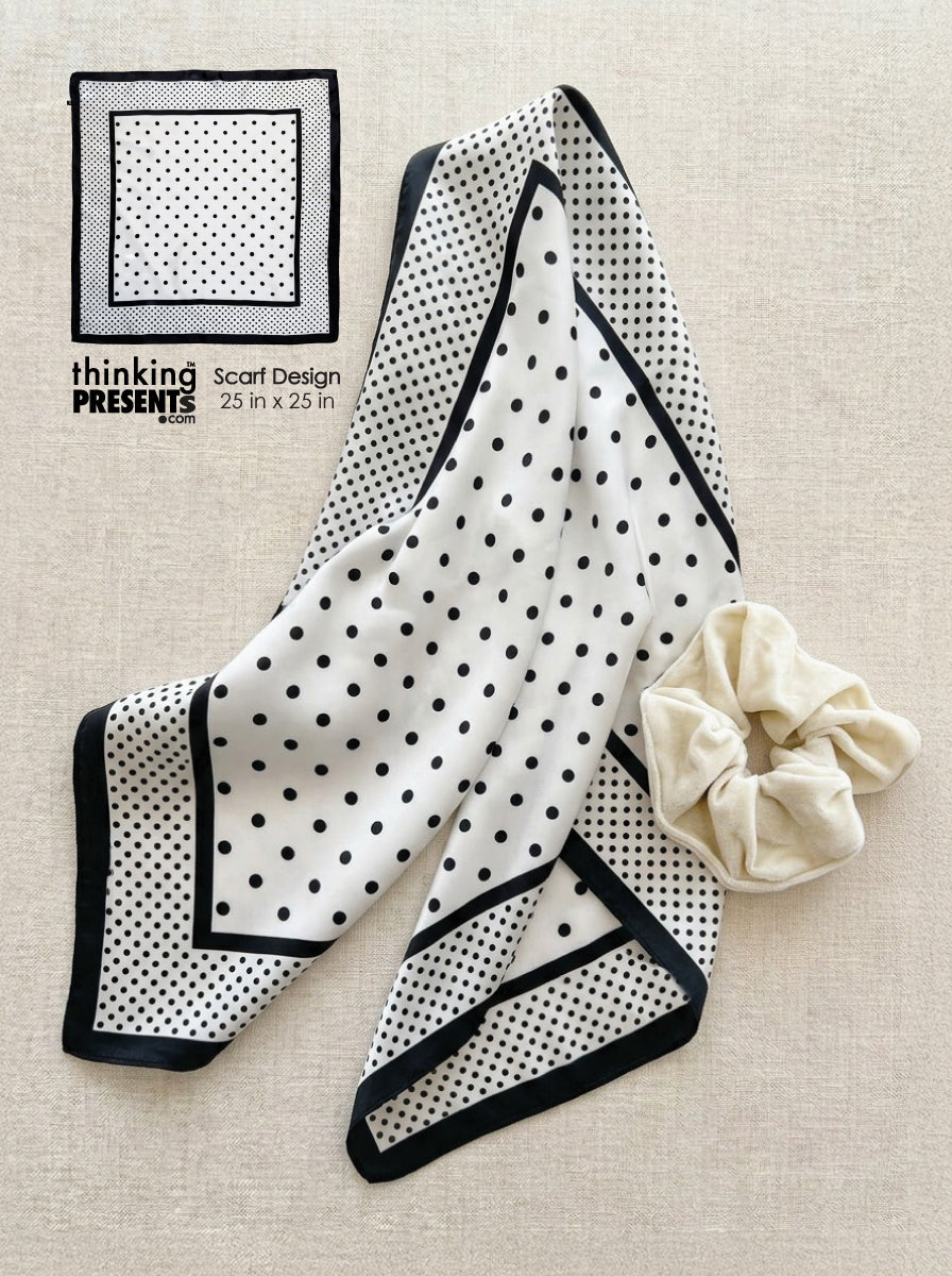 Black and white polka dot scarf with a matching scrunchie on a beige background