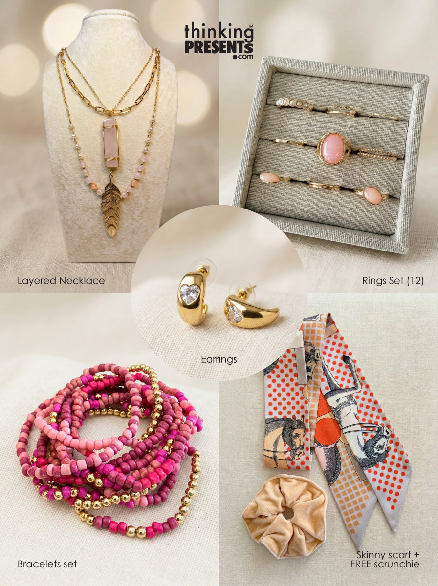 Curated gift set featuring layered gold-tone necklace with pink stone pendant, matching hoop earrings with heart detail, twelve-piece ring set with blush stones, stackable pink beaded bracelets, and a patterned skinny scarf with scrunchie, styled as a feminine ready-to-gift set