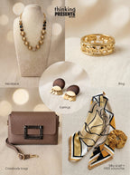 Savanna Glow gift set featuring gold beaded statement necklace, elephant motif ring, wood and gold drop earrings, brown crossbody bag, silky patterned scarf and velvet scrunchie
