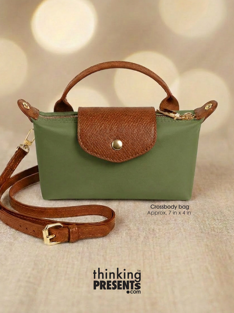 Green handbag with brown handle and strap on a beige background