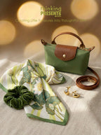 Green handbag with matching scarf, scrunchie, and earrings on a neutral background with 'thinking presents' branding.