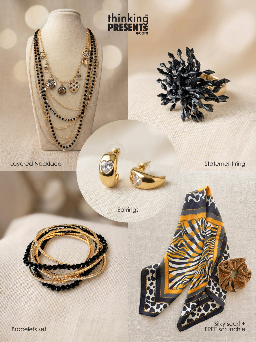 Multi-layered gold-tone necklace with black bead accents, statement ring, crystal-accent earrings, and stackable bracelets set, paired with an animal print silky scarf and velvet-touch scrunchie, part of the Urban Safari Gift Set by Thinking Presents™