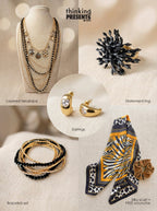Multi-layered gold-tone necklace with black bead accents, statement ring, crystal-accent earrings, and stackable bracelets set, paired with an animal print silky scarf and velvet-touch scrunchie, part of the Urban Safari Gift Set by Thinking Presents™