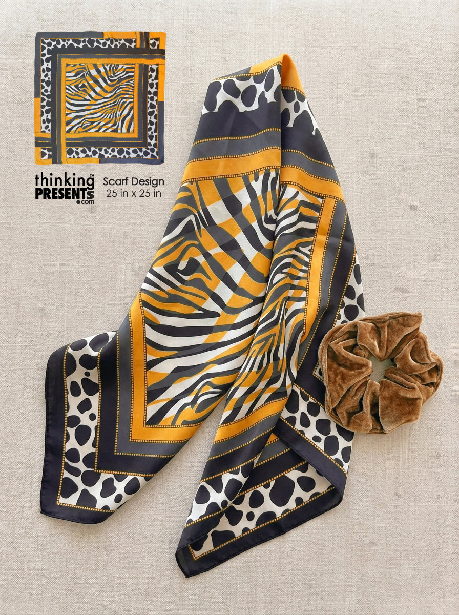 Patterned scarf with a scrunchie on a textured surface, featuring 'thinking presents' branding.