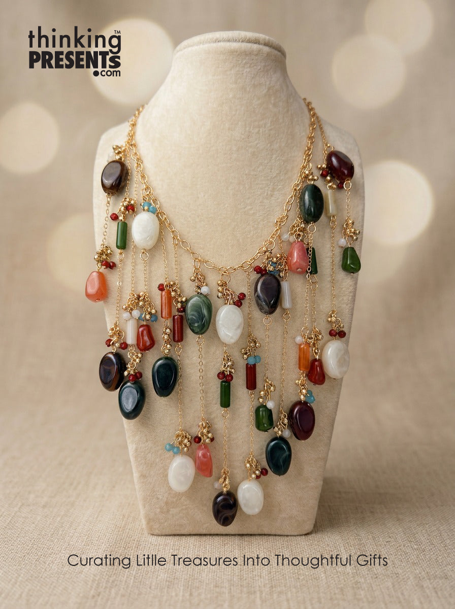 Statement necklace with cascading multicolor stones and gold-tone chains, featuring layered earthy gemstone accents in a bold, boho-inspired design by Thinking Presents™