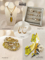 Curated gift set featuring layered gold-tone necklace with amber pendant, six-piece ring set, gold hoop earrings, stackable yellow-toned bracelets, and a floral silky scarf with scrunchie, styled as a bright and elegant ready-to-gift set
